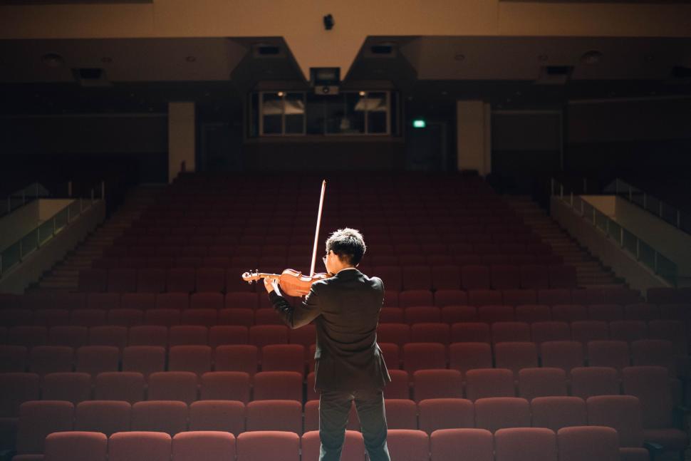 Free Image of Man Holding Violin on Stage 