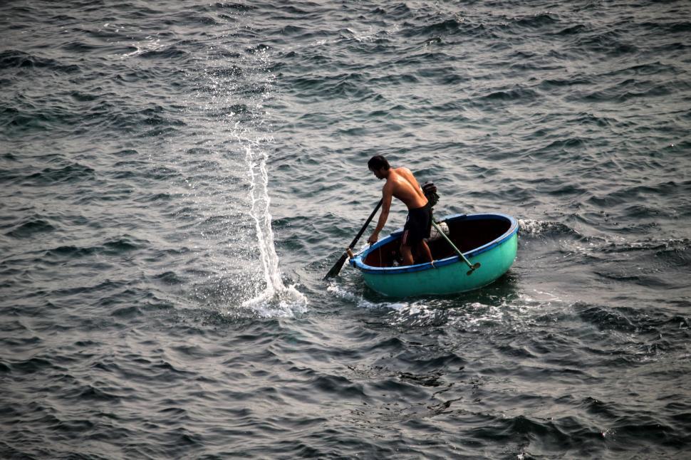 Free Image of Man Rowing Boat in Middle of Ocean 