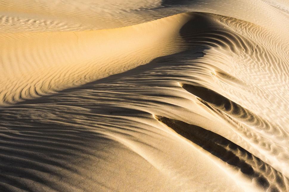 Free Image of Massive Sand Dune Rising in Desert Landscape 