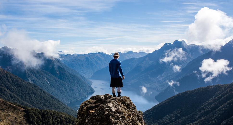 Free Image of Person Standing on Top of a Mountain 