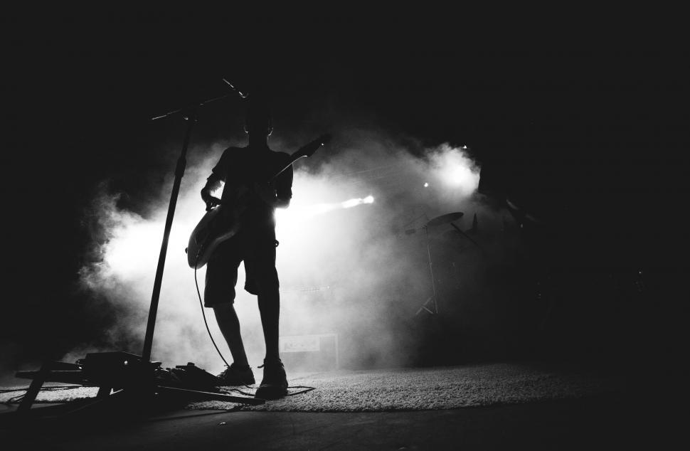 Free Image of Person Playing Guitar in Black and White 
