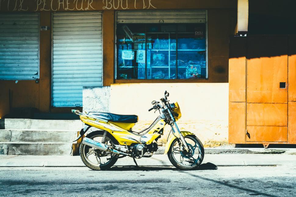 Free Image of Yellow Motorcycle Parked in Front of Building 