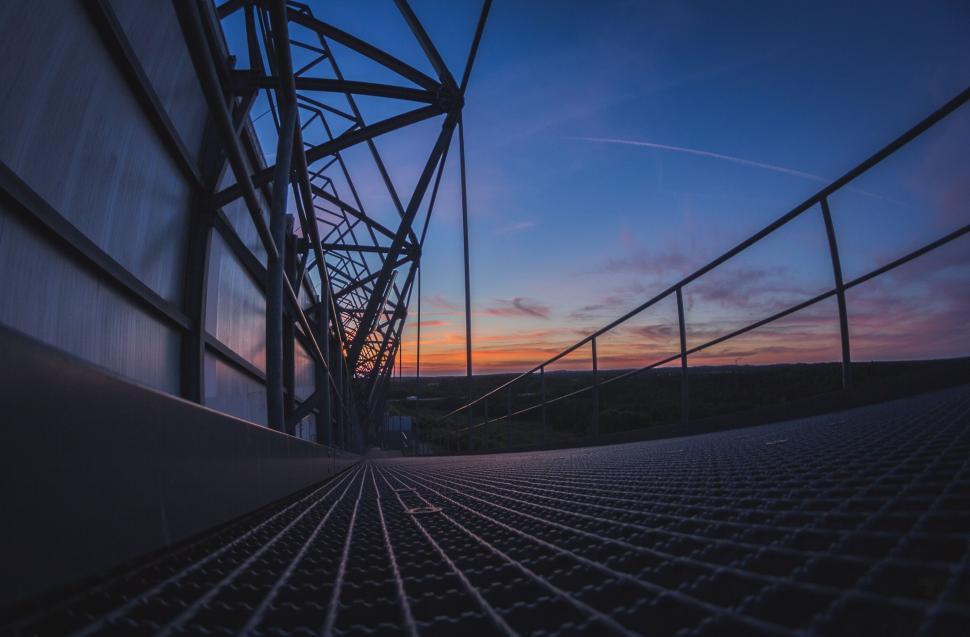 Free Image of Sun Setting Behind Metal Structure 