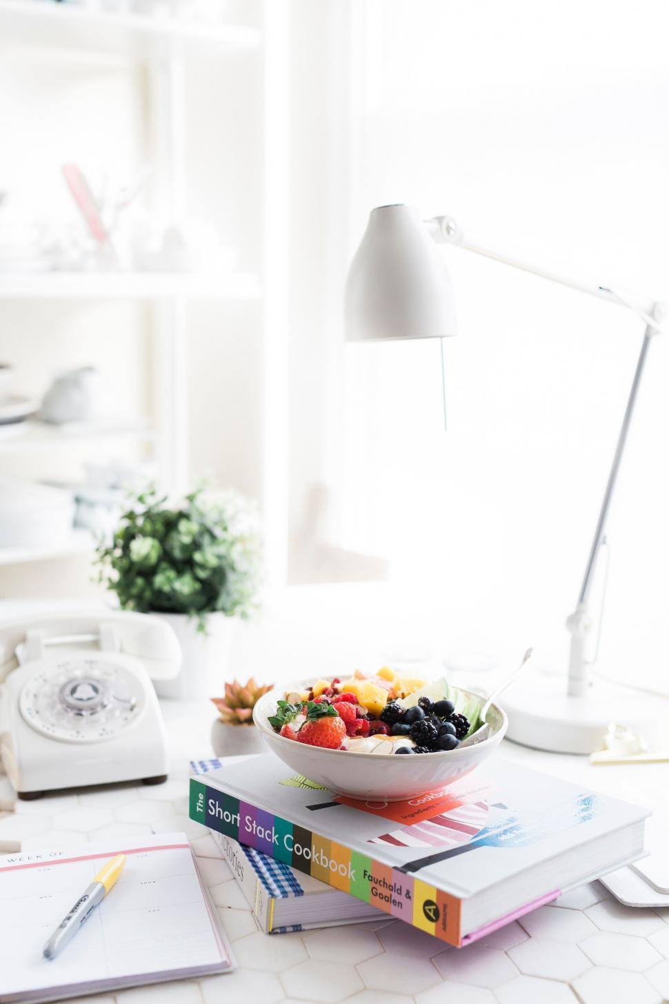 Free Image of Bowl of Fruit on Stack of Books 