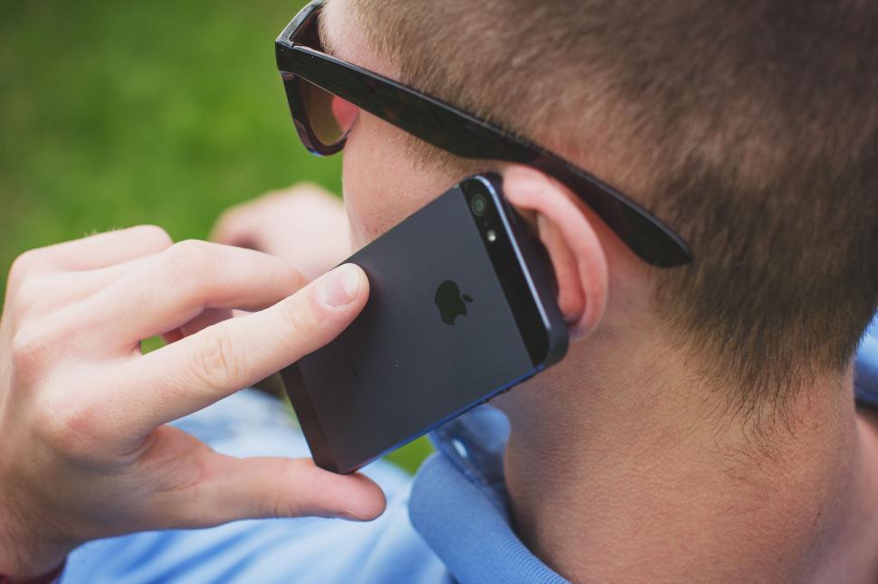 Free Image of Man Wearing Sunglasses Talking on Cell Phone 