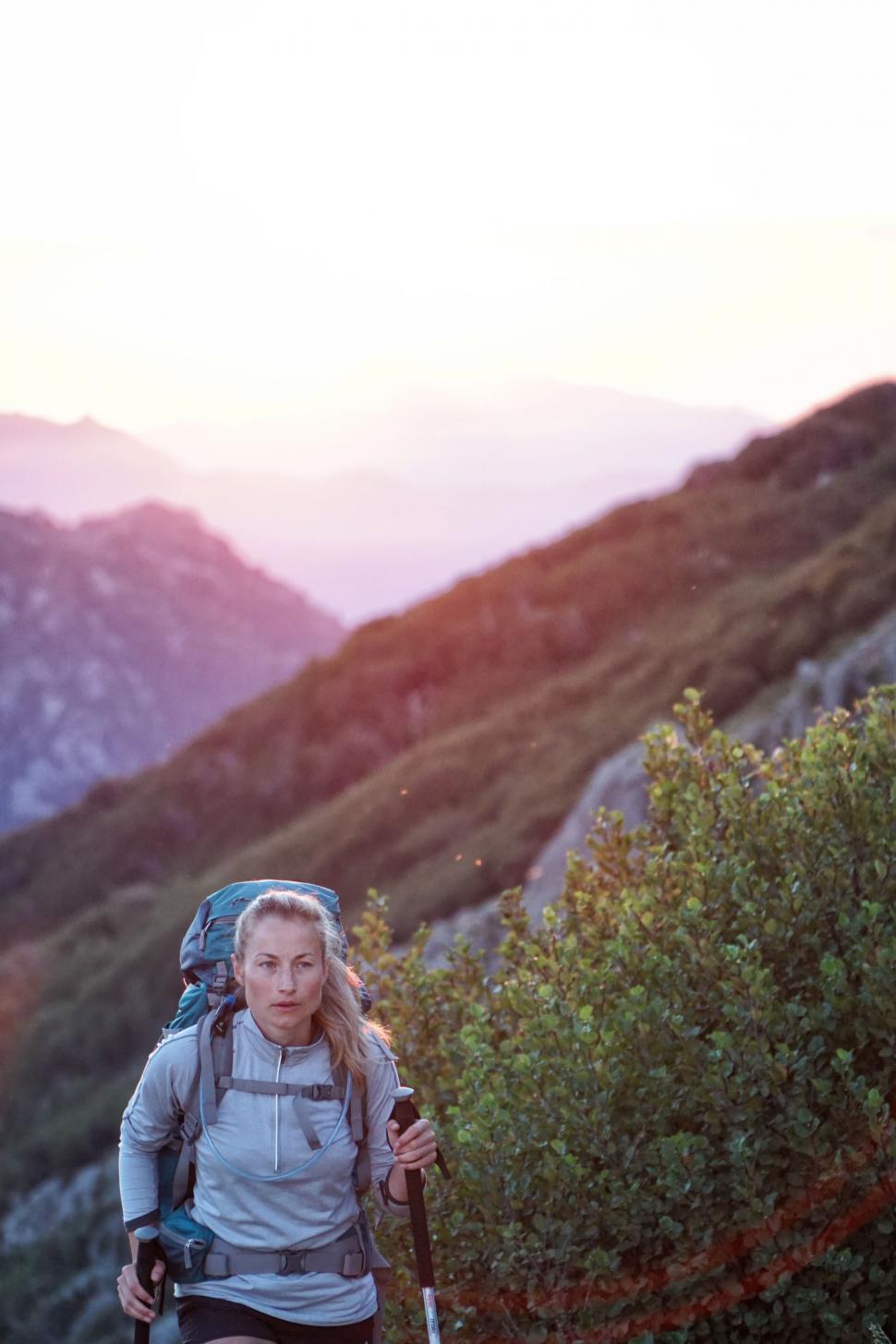 Free Image of Woman Hiking Up a Mountain With a Backpack 
