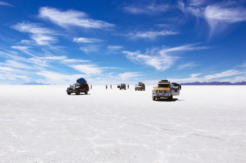 Free Image of Group of Trucks Driving Across a White Desert 