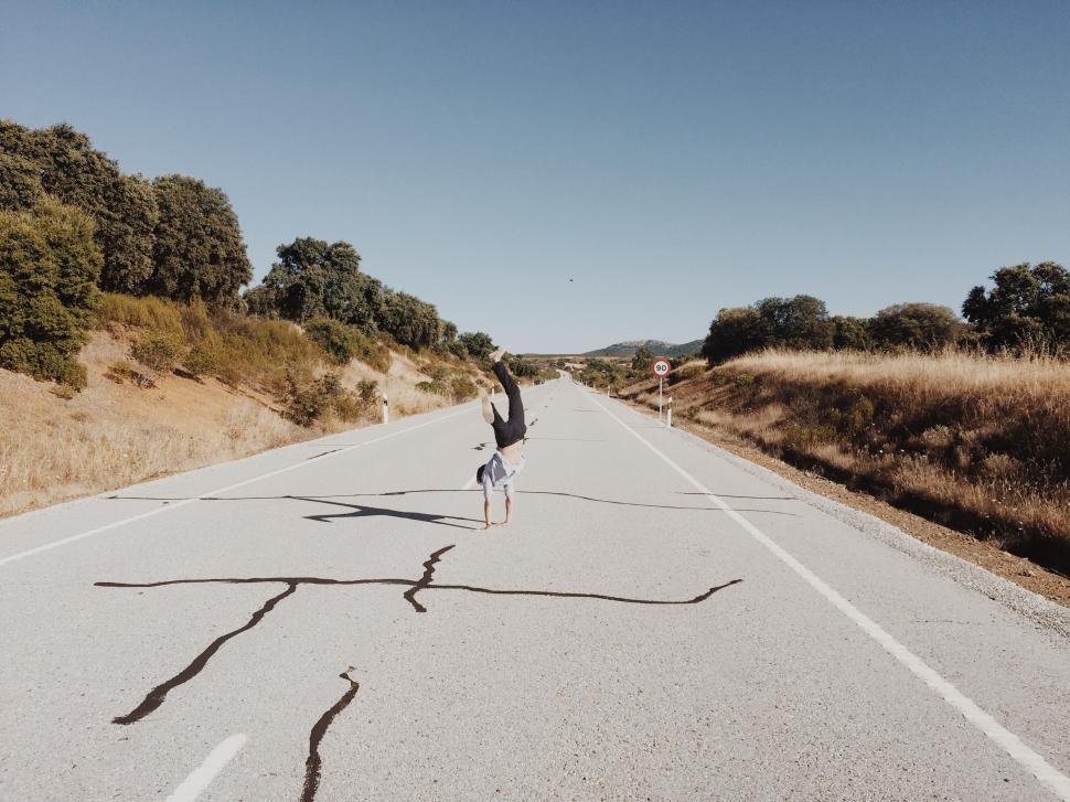 Free Image of Person Riding Skateboard Down Road 