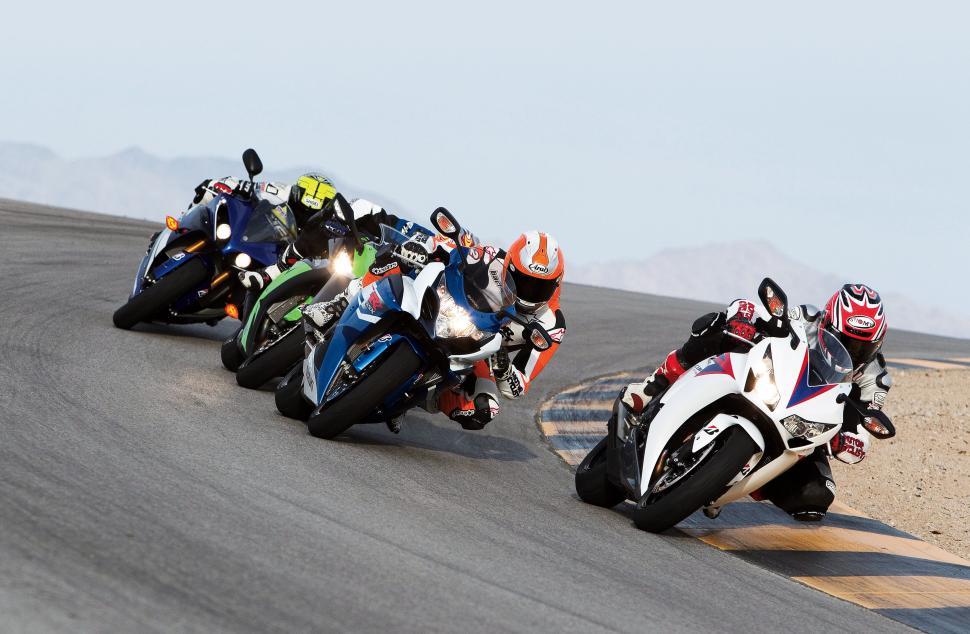 Free Image of Group of People Riding Motorcycles on Race Track 