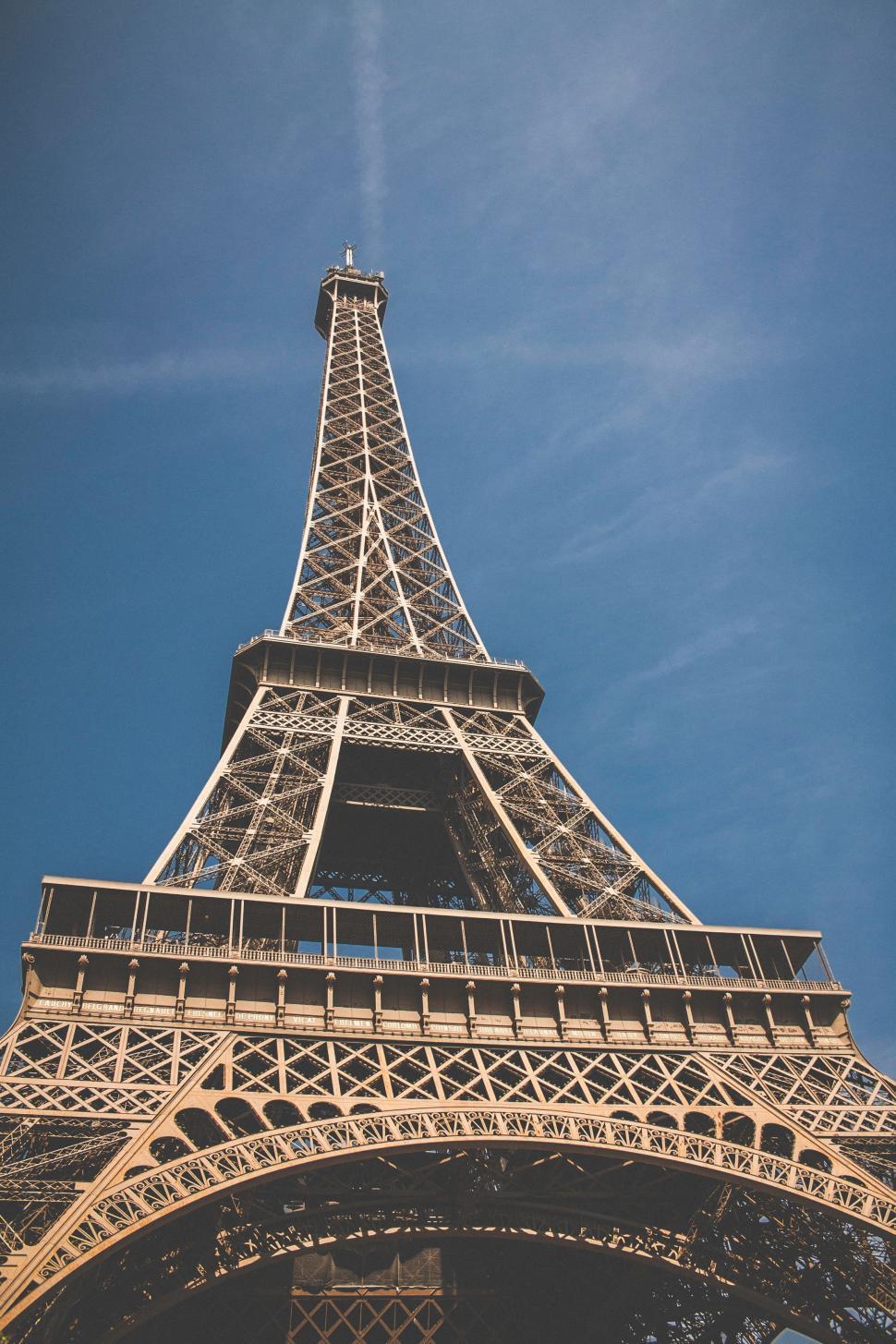 Free Image of The Top of the Eiffel Tower Against a Blue Sky 