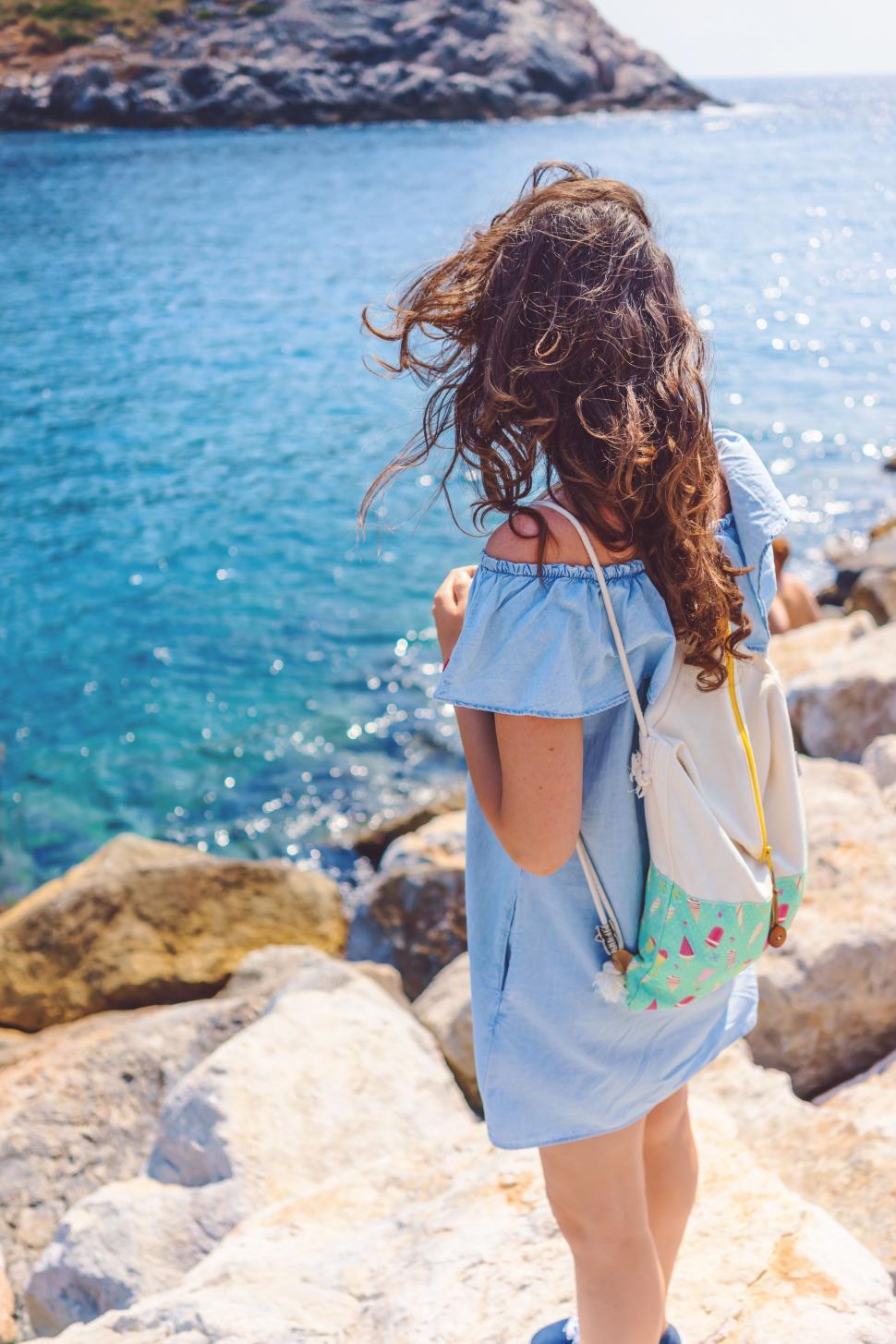 Free Image of Little Girl Standing on Rocks, Looking at Water 