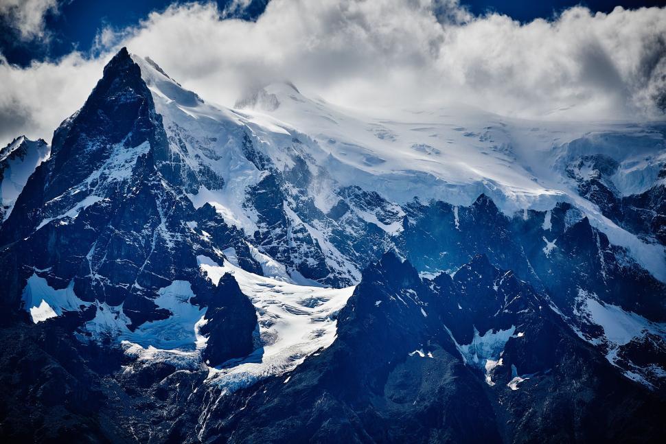 Free Image of Snow Covered Mountain With Clouds in the Sky 