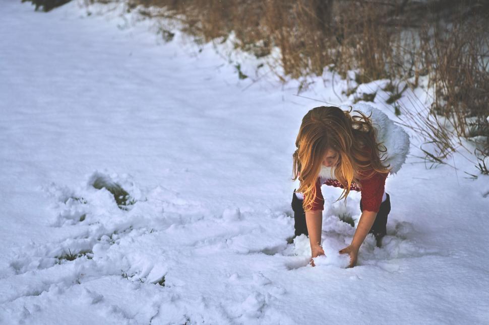 Free Image of Woman Bending Over in Snow 