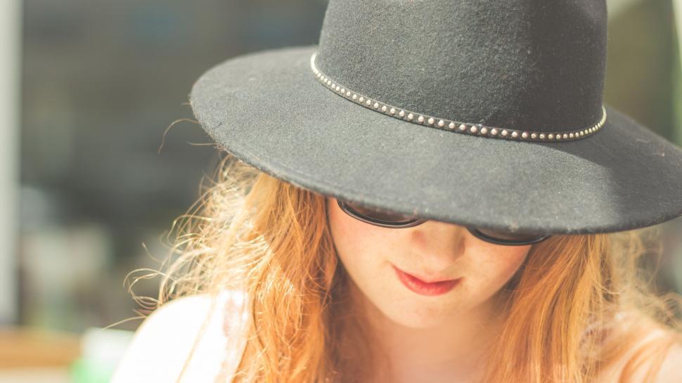 Free Image of Woman With Red Hair Wearing a Black Hat 