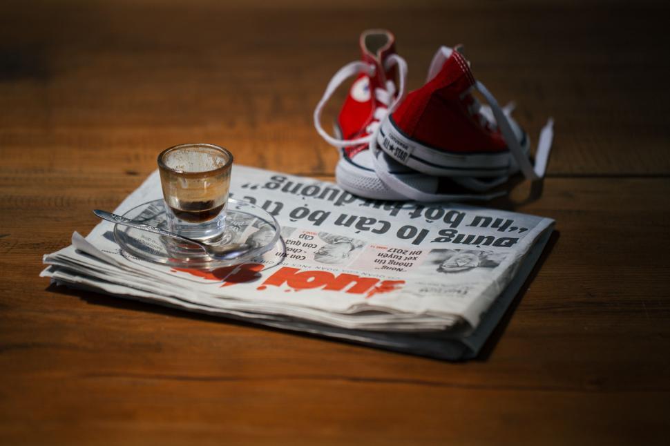Free Image of Newspaper, Glass of Water, Sneakers 