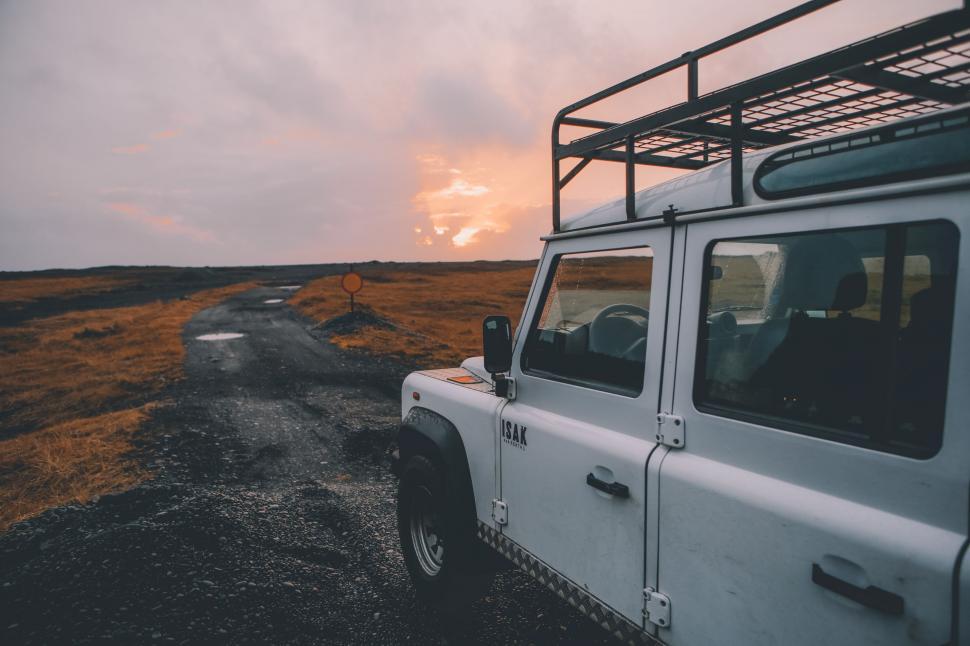 Free Image of White Jeep Parked on Dirt Road 