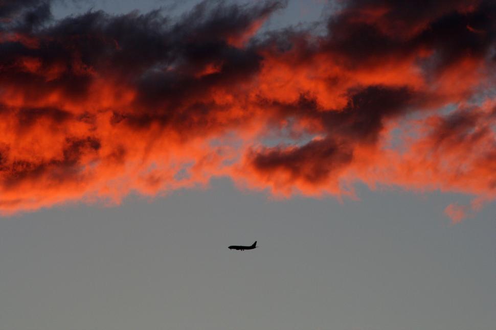 Free Image of Plane Flying in the Sky at Sunset 