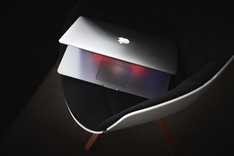 Free Image of Apple Laptop Emitting Red Light 