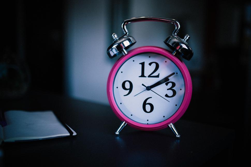 Free Image of Pink Alarm Clock on Table 