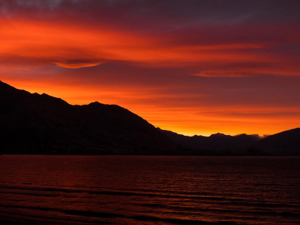 Free Image of Majestic Sunset Over Lake and Mountains 