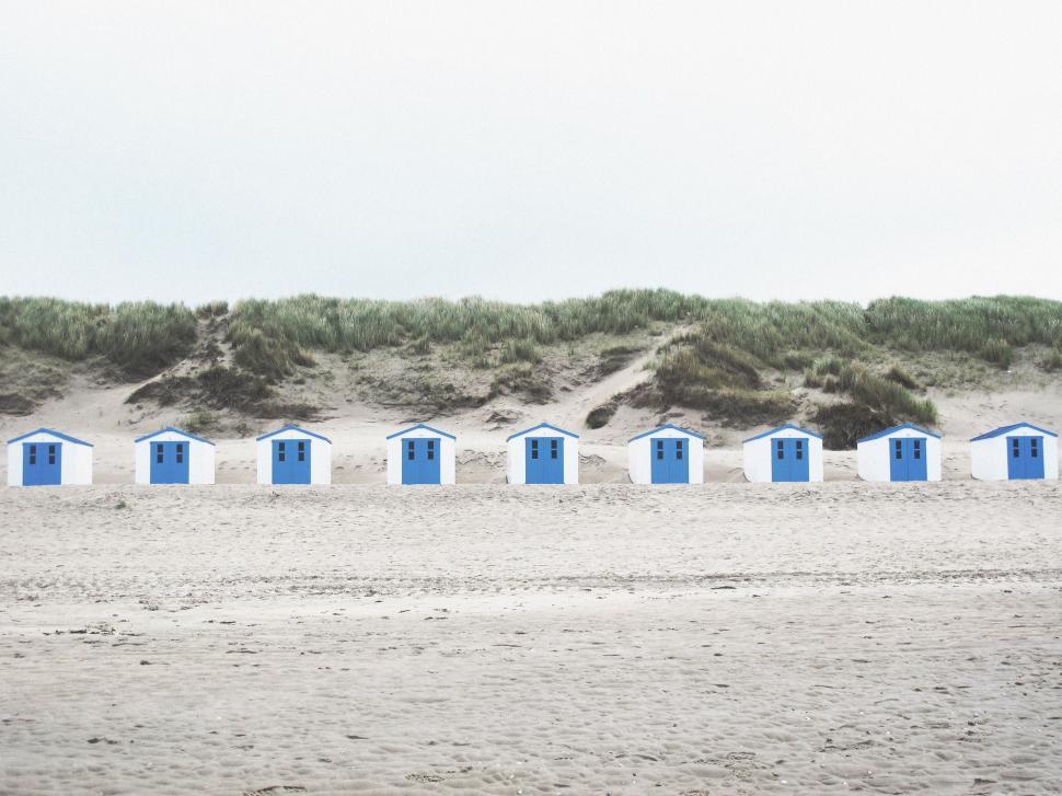 Free Image of Row of Beach Huts on Sandy Beach 