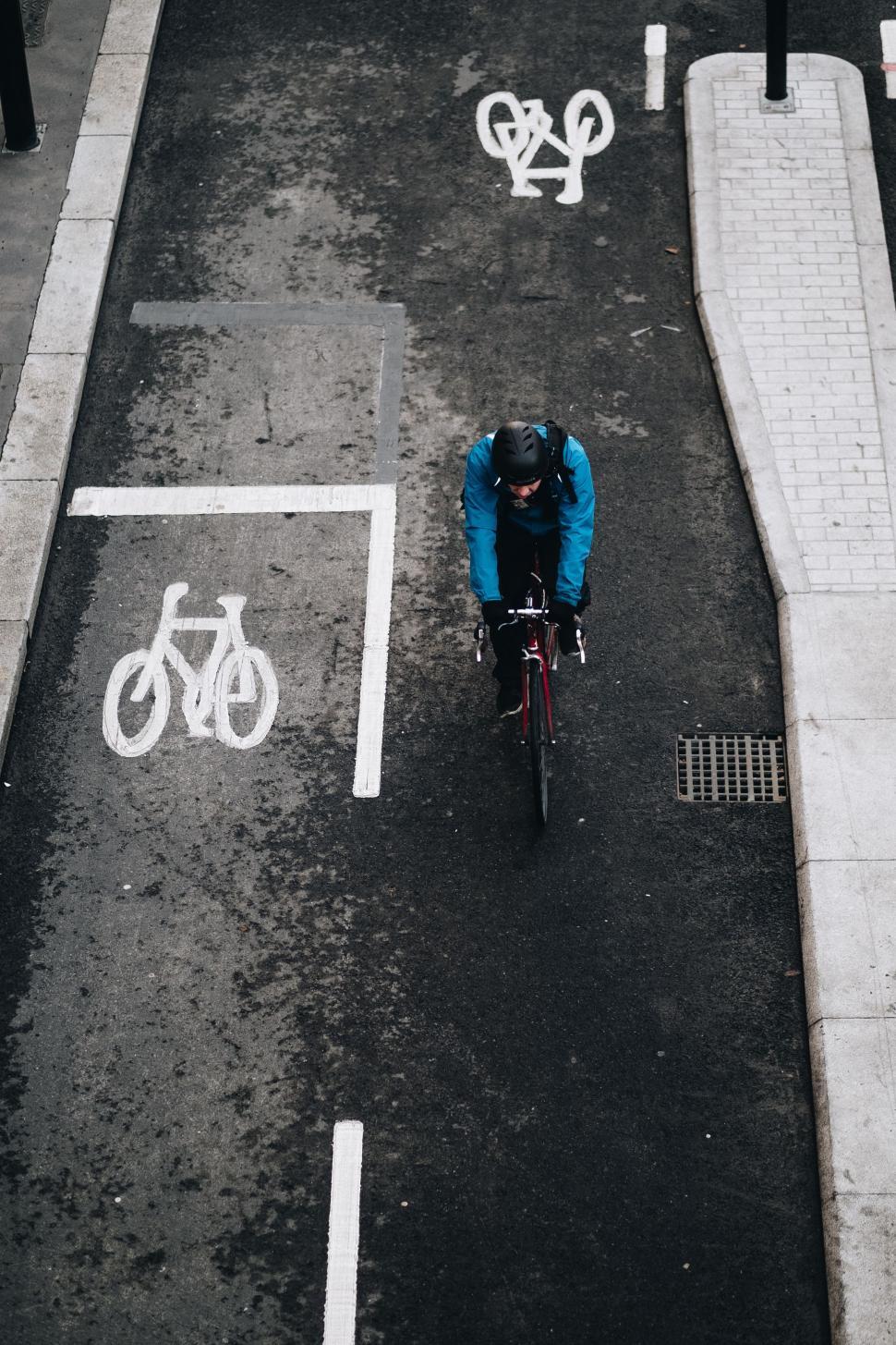 Free Image of Person Riding Bike in Parking Lot 