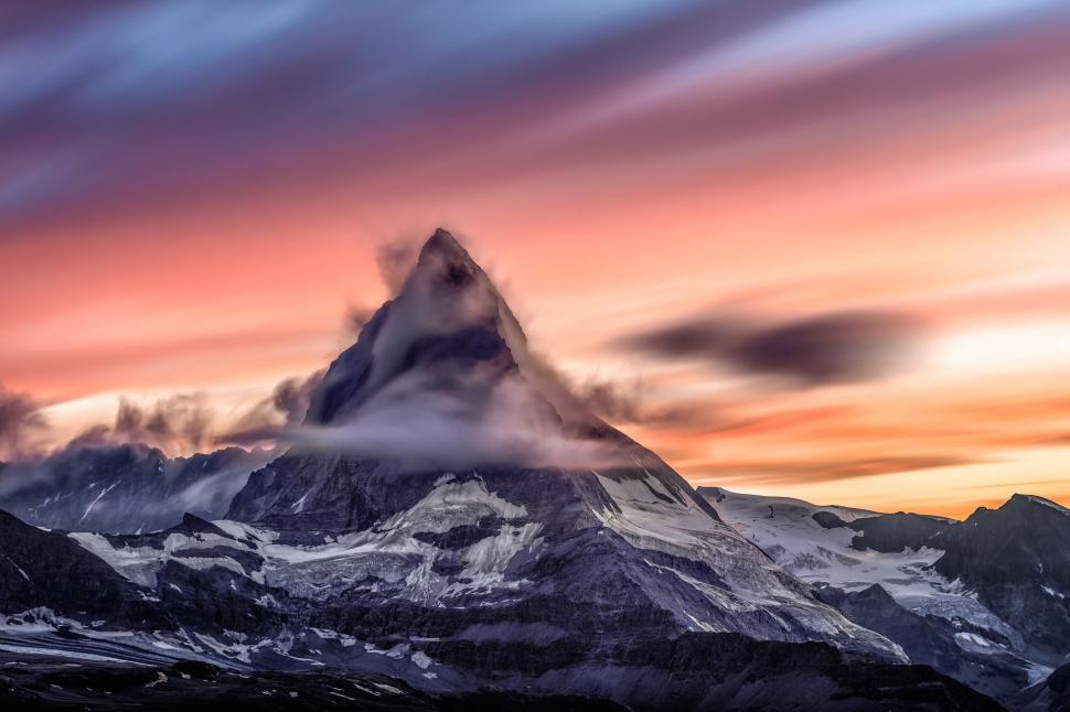 Free Image of Mountain Covered in Clouds at Sunset 