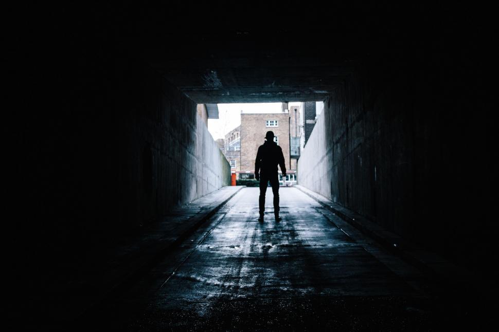 Free Image of Man Standing in Dark Tunnel 