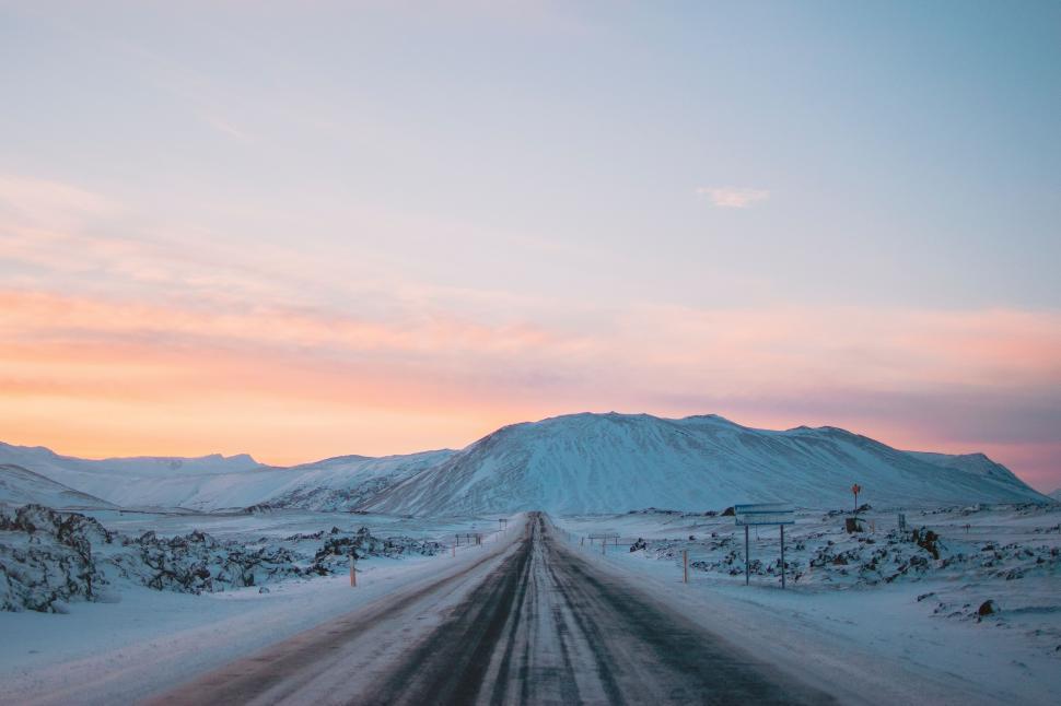 Free Image of Snow Covered Road With Mountain in the Background 