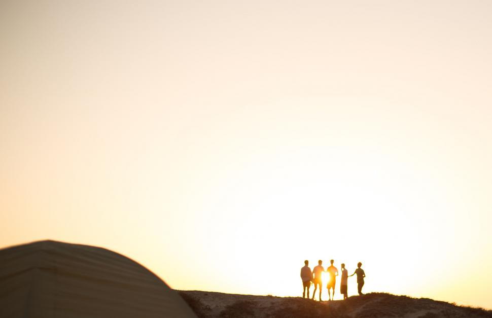 Free Image of Group of People Standing on Top of Sandy Hill 