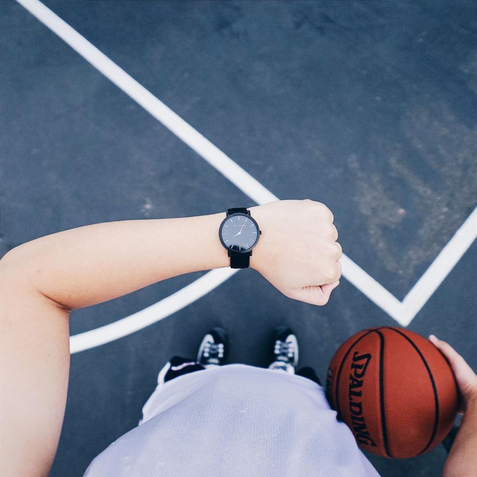 Free Image of Person Holding Basketball on Basketball Court 