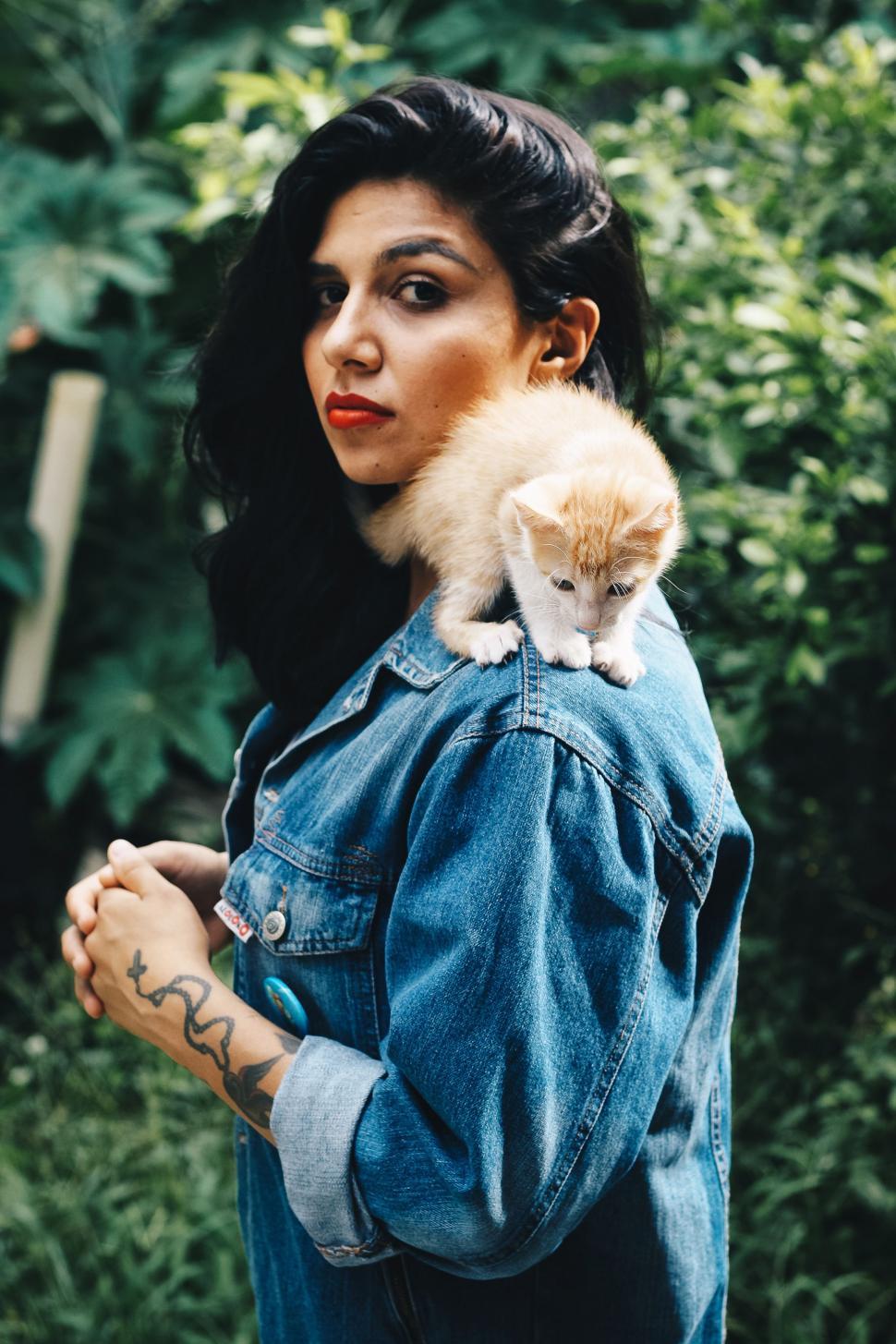 Free Image of Woman Carrying Cat on Shoulders 