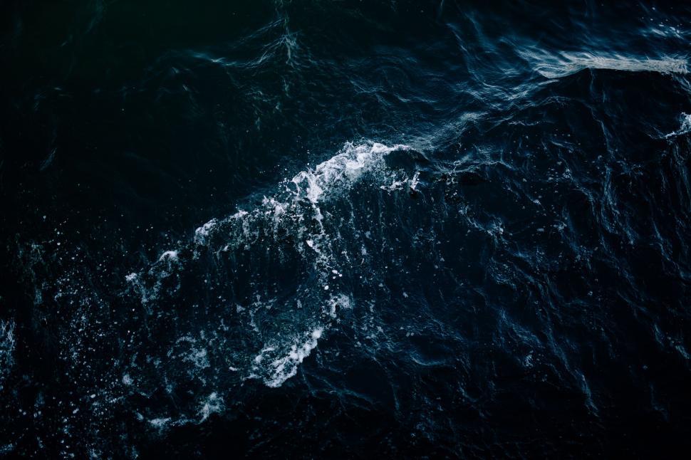 Free Image of Dark Blue Waves Roiling on Large Body of Water 