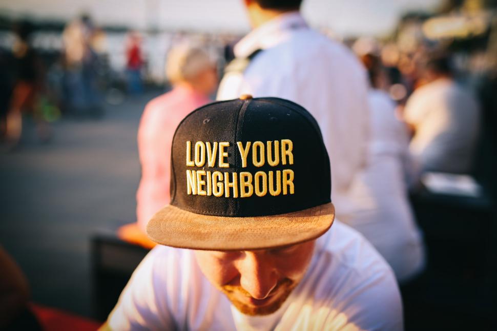 Free Image of Man Wearing Hat With Love Your Neighbor 