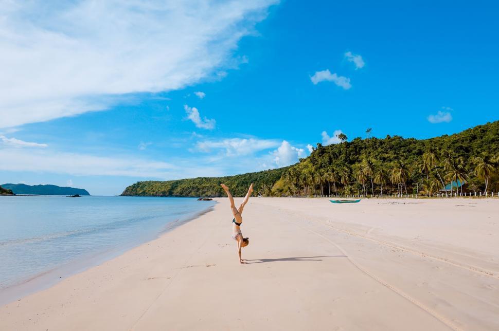 Free Image of Person Performing Handstand on Beach 