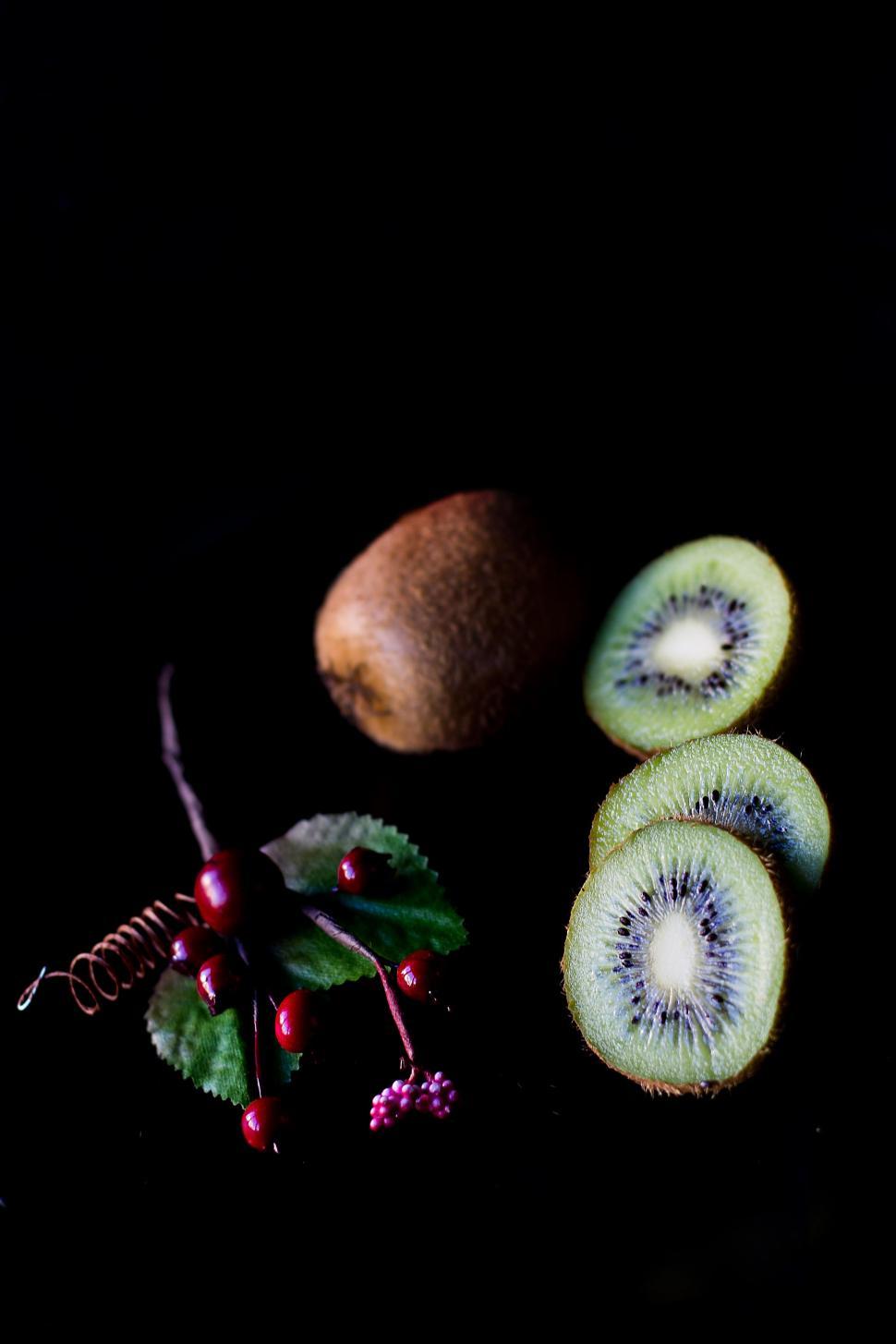 Free Image of Kiwis and Berries on a Black Background 