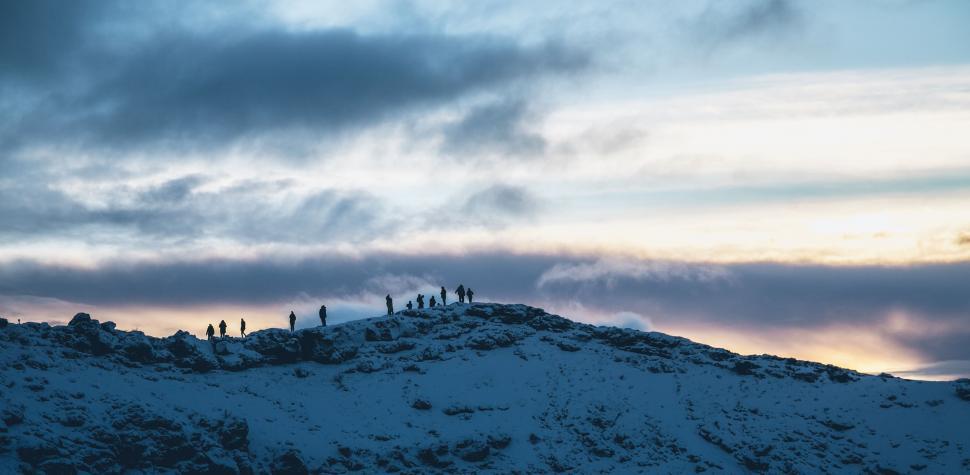 Free Image of Group of People Standing on Top of Snow Covered Mountain 