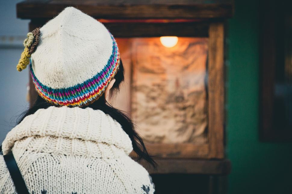 Free Image of Woman Wearing White Sweater and Colorful Hat 