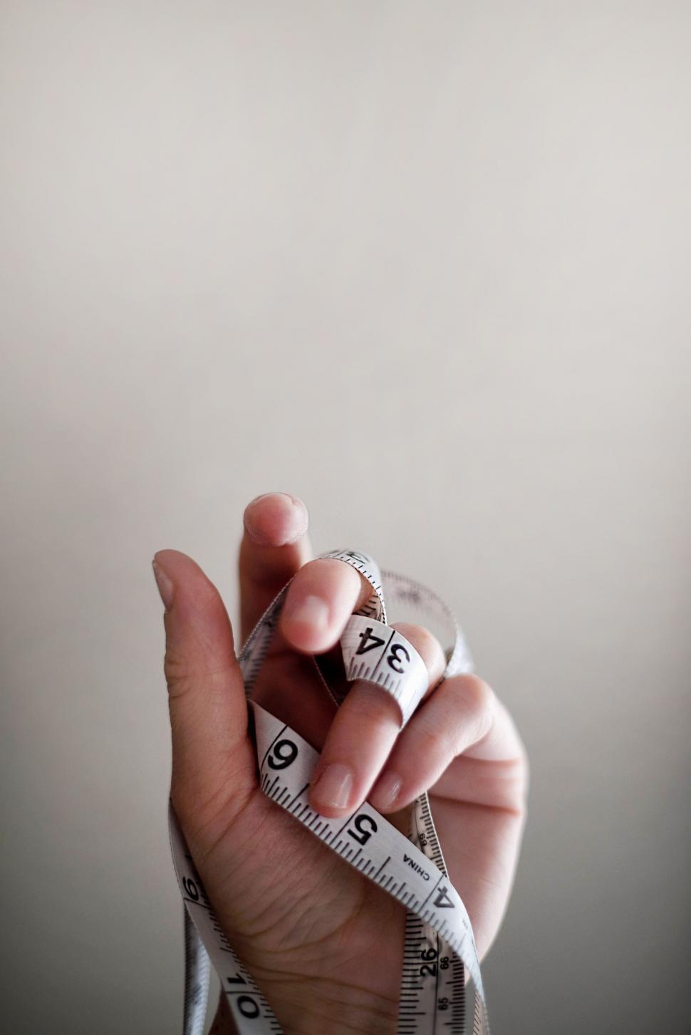 Free Image of Person Holding a Measuring Tape 