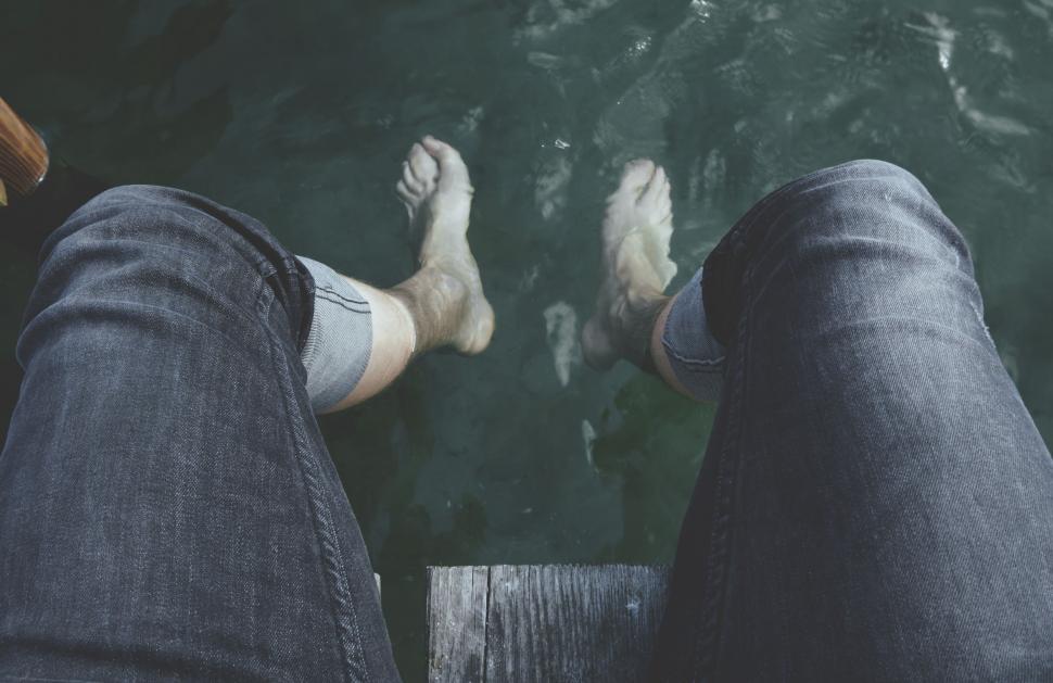 Free Image of Person Standing on Dock With Feet in Water 