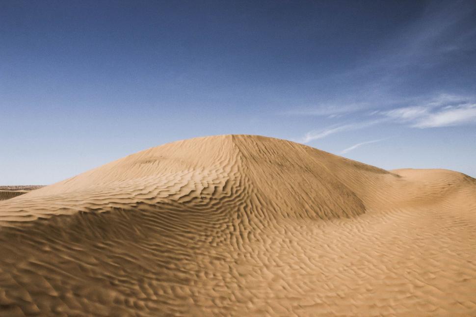 Free Image of Massive Sand Dune Rises in Desert Landscape 