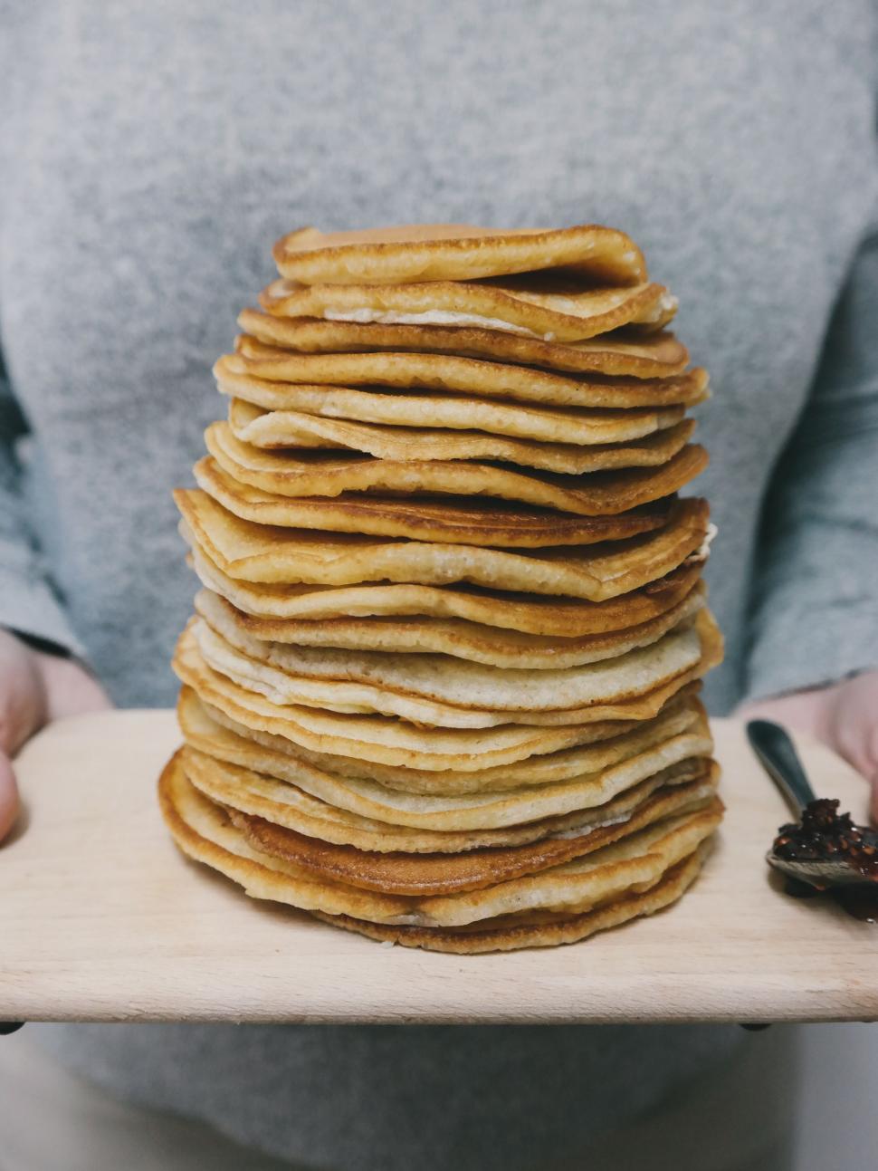Free Image of Person Holding Plate of Food With Stack of Pancakes 