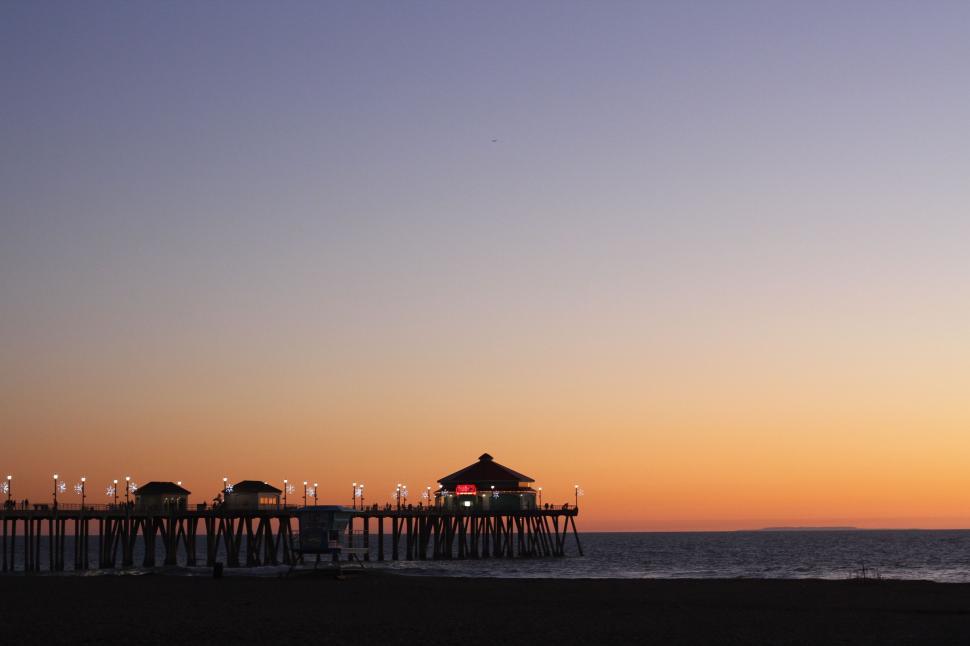 Free Image of Pier at Sunset on Beach With Sky Background 