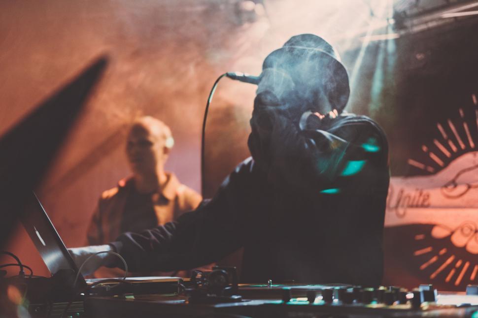 Free Image of Man in a Black Hoodie Playing a DJ Set 