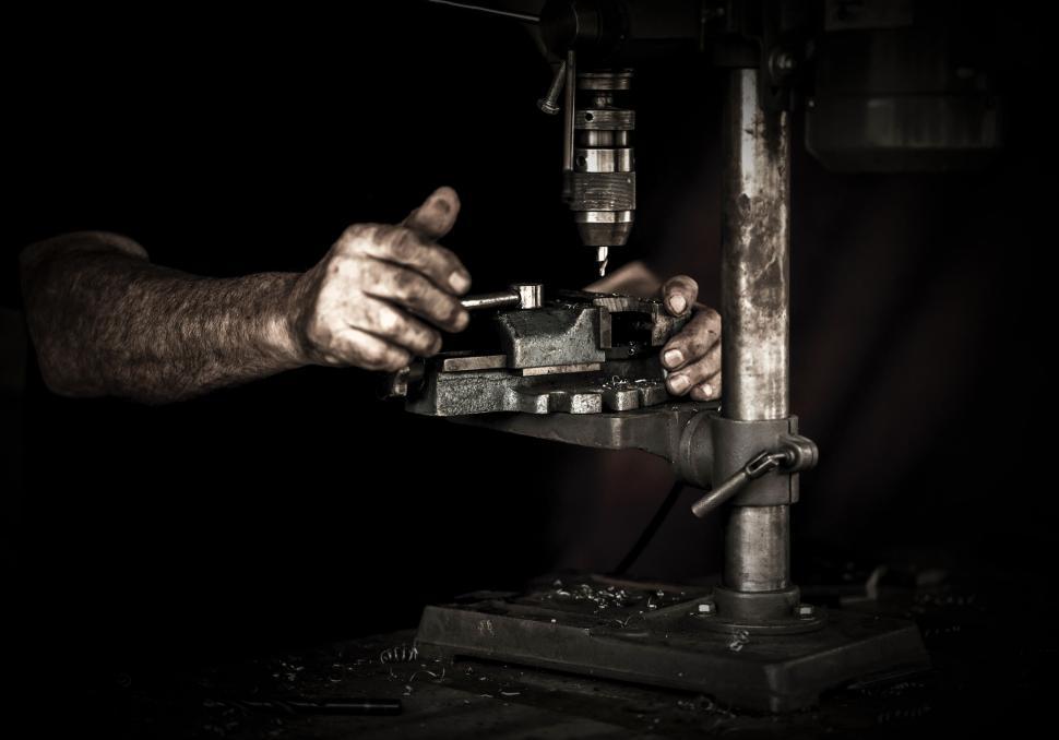 Free Image of Man Working on Machine in Black and White 