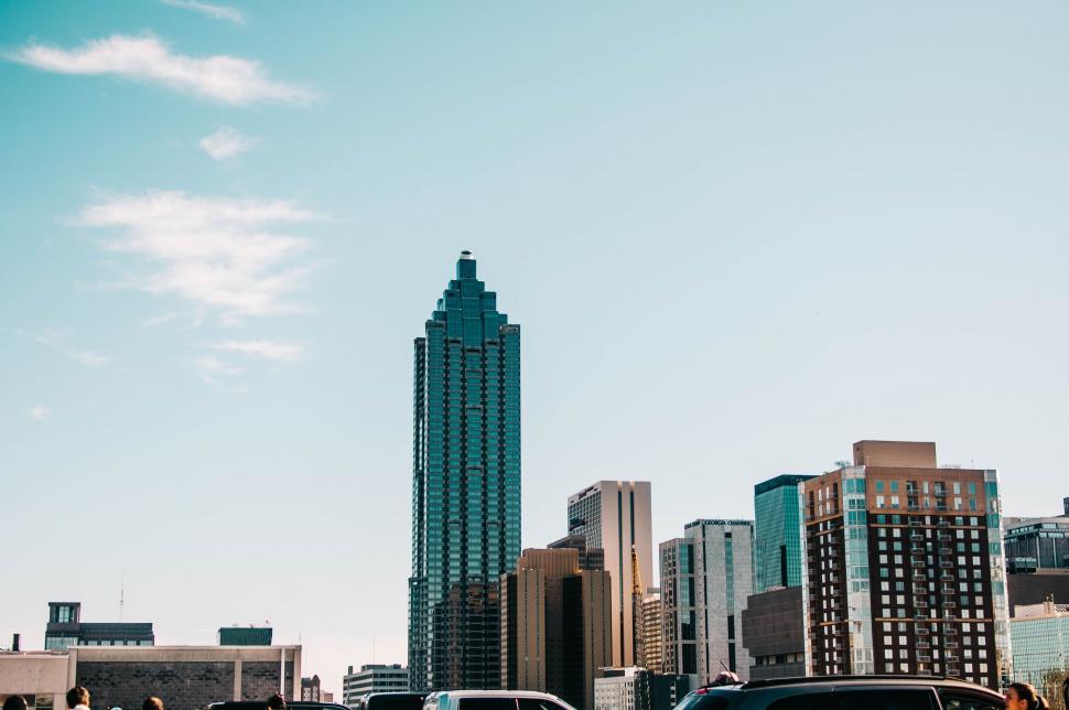 Free Image of Cars Driving Down Street Next to Tall Buildings 