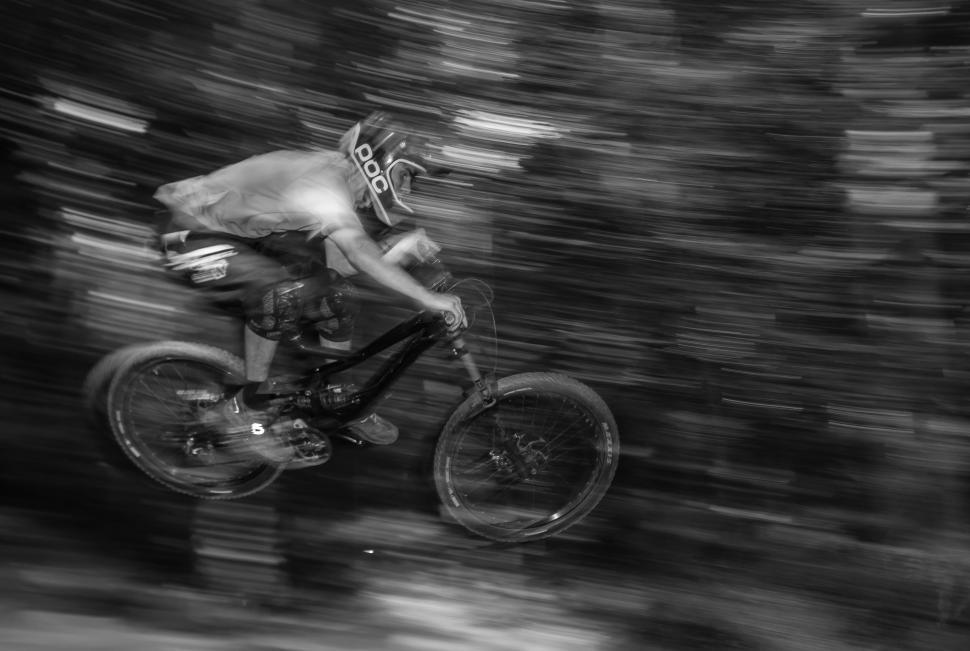 Free Image of Person Riding a Bike in Black and White 