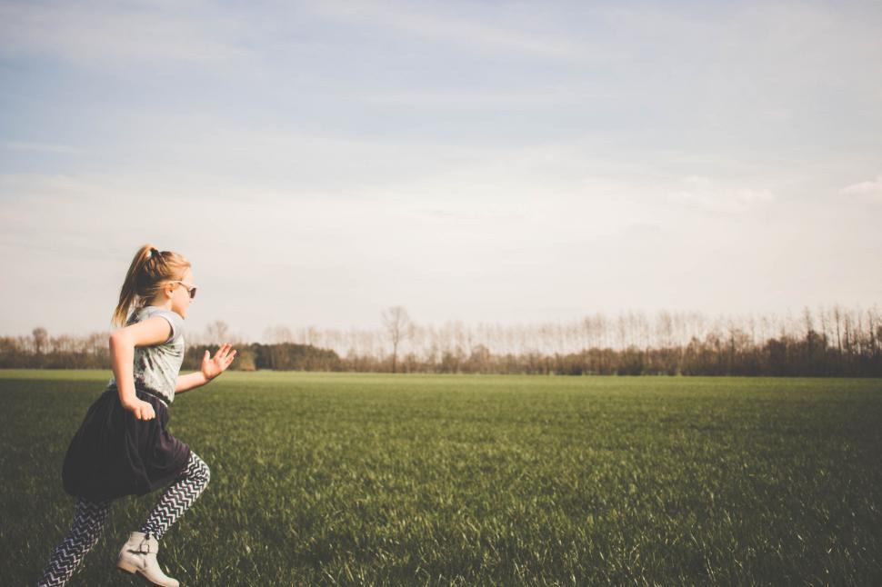 Free Image of Woman Running Through a Field of Grass 