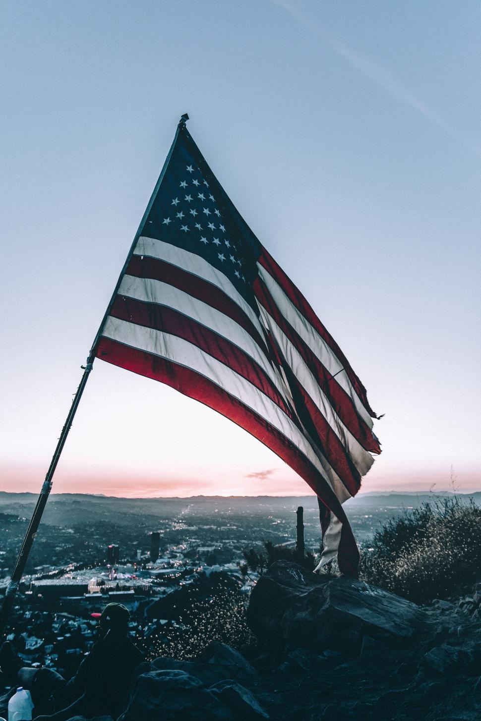 Free Image of Large American Flag on Top of a Mountain 