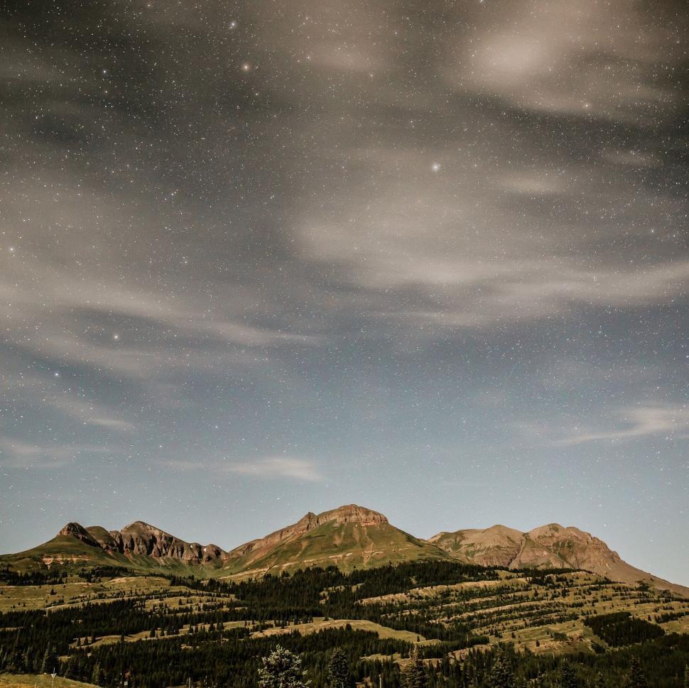 Free Image of Majestic Mountain Range Under a Starry Night Sky 